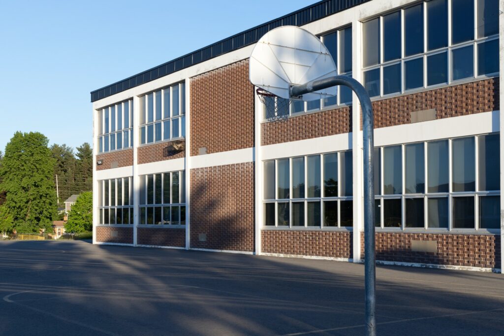 School building and school yard with basketball court