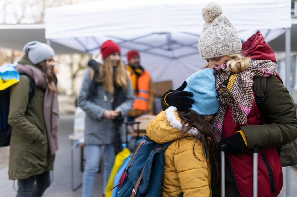 Ukrainian refugee mother with child crossing border