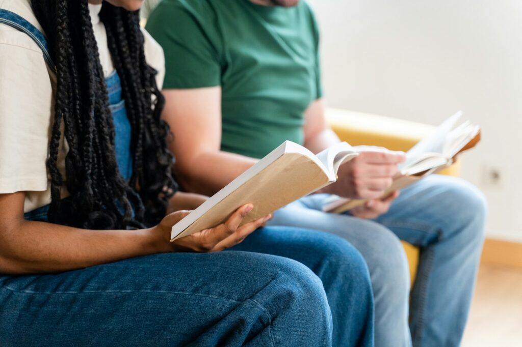 Man and woman reading a book in a book club.